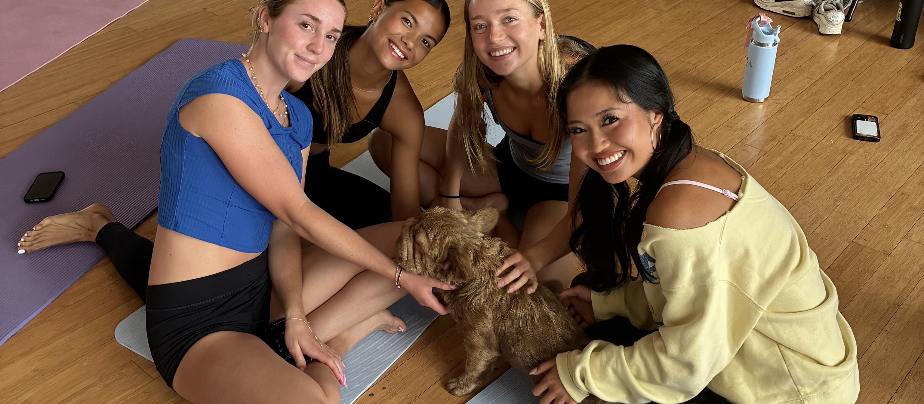Friends celebrating together at a puppy yoga class in Westwood LA