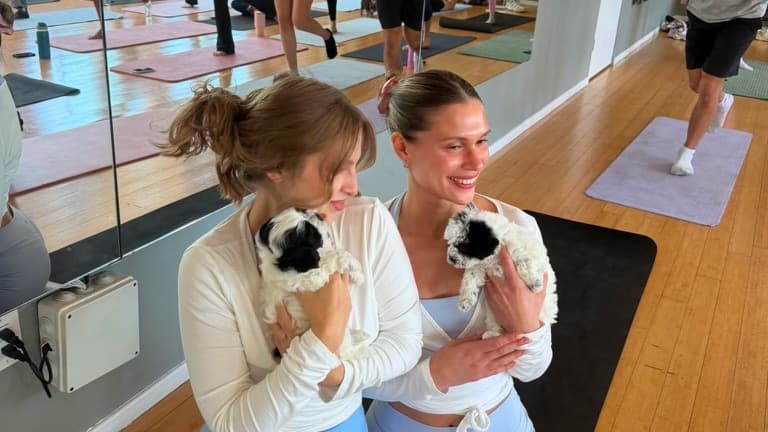 A couple sharing a calm moment with a puppy during a Los Angeles yoga class