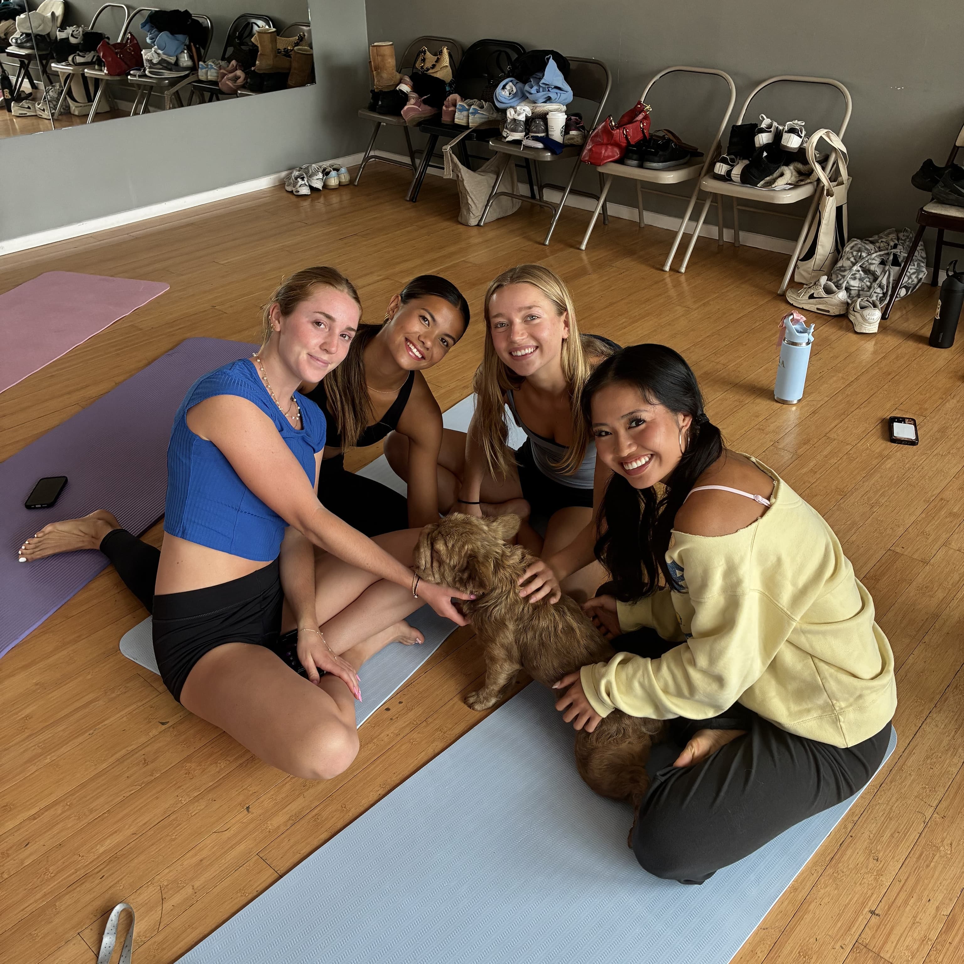 A bachelorette group cuddling puppies at a puppy yoga class in LA