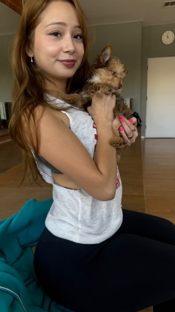 Cuddling with puppies during a puppy yoga date class in LA